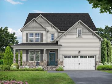 Charming two-story home with stone accents, a covered porch, a lawn, and an attached two-car garage at 456 Golden Dragonfly St, Wake Forest, NC 27587