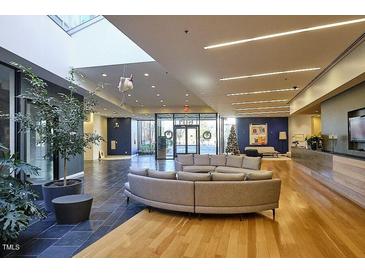 Bright lobby area with lounge seating and skylight, showcasing modern design elements and open space at 601 W Rosemary St # 712, Chapel Hill, NC 27516