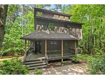 Stunning multi-story house featuring a cozy front porch and beautiful natural wood accents at 6412 Heartwood Dr, Chapel Hill, NC 27516