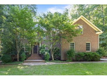 Charming brick home with mature trees, offering a tranquil and private setting at 1003 Gloucester Ct, Chapel Hill, NC 27516