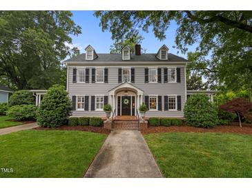 Charming two-story home with a well-manicured lawn and traditional architectural details at 1015 Watts St, Durham, NC 27701