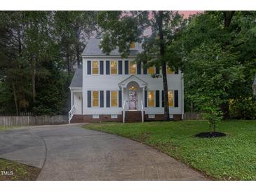 Charming two-story home featuring a well-manicured lawn and a curved driveway at 105 Houston Cir, Cary, NC 27513