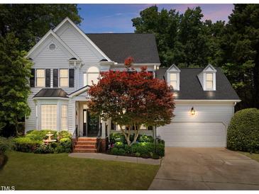 Charming two-story home with lush landscaping, brick stairs, and a two-car garage at 107 Ashwick Ct, Cary, NC 27513