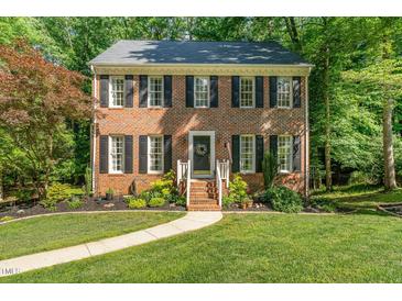 Charming brick home with black shutters and landscaped front yard at 1104 Berwyn Way, Raleigh, NC 27615