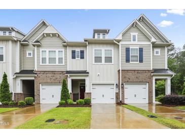 Charming townhomes boast brick accents, inviting garages, and well-manicured lawns at 127 Manordale Dr, Chapel Hill, NC 27517