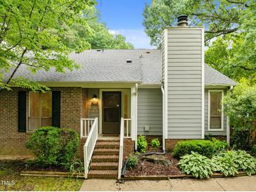 Charming home featuring brick accents, siding, chimney and landscaped garden beds, providing a welcoming curb appeal at 173 Clancy Cir, Cary, NC 27511
