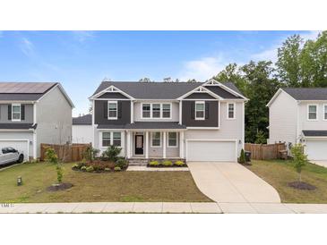Charming two-story home with landscaped yard, black shutters, and attached two-car garage at 188 Karlov Rd, Garner, NC 27529