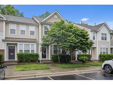 Charming townhouse with meticulously maintained landscaping, neutral exterior, and welcoming entrance at 214 Cedar Elm Rd, Durham, NC 27713