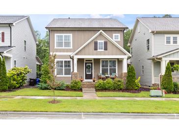 Charming two-story home with stone accents, inviting front porch, and well-maintained landscaping at 306 Crossland Dr, Chapel Hill, NC 27517