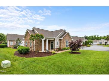 Charming single-story home with stone accents, a well-manicured lawn, and inviting curb appeal at 306 Faith Dr, Gibsonville, NC 27249