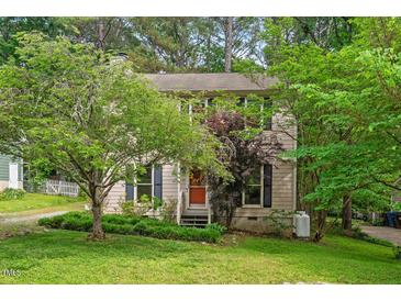 Charming home with a well-maintained lawn and mature trees providing ample shade at 3405 Bonaparte Way, Durham, NC 27707