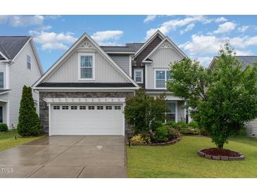 Charming two-story home featuring stone accents, a two-car garage, and a beautifully landscaped front yard at 3904 Freemark Ln, Fuquay Varina, NC 27526
