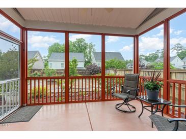 Relaxing screened porch with comfortable seating and a serene view of the backyard and community at 3904 Freemark Ln, Fuquay Varina, NC 27526