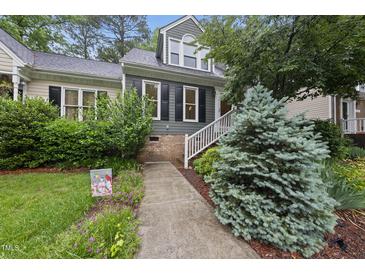 Charming home featuring a well-manicured front yard with a welcoming walkway and tasteful landscaping at 3940 Lake Ferry Dr, Raleigh, NC 27606