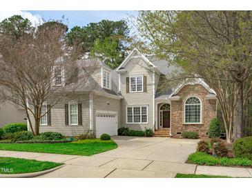 Charming two-story home featuring a blend of stone and siding, well-manicured lawn and a welcoming entrance at 5410 Highcroft Dr, Cary, NC 27519