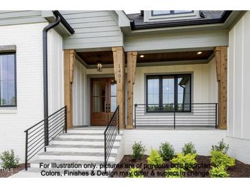 Inviting entrance with stone steps, wood columns, and dark window and railing accents at 8021 Bud Morris Rd, Wake Forest, NC 27587
