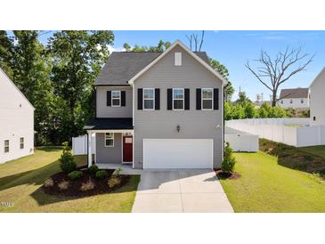 Charming two-story home with gray siding, black shutters, and a well-manicured lawn at 1028 Gallivant Way, Wake Forest, NC 27587