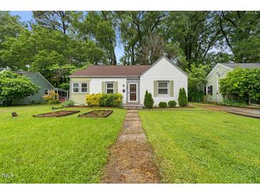 Charming home with a well-manicured lawn and inviting front yard landscaping at 109 Davidson Ave, Durham, NC 27704