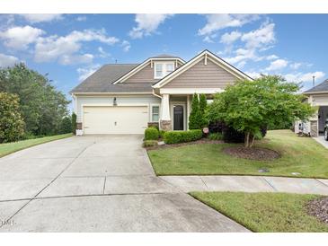 Charming single-Gathering home featuring a well-manicured lawn and a two-car garage at 1528 Anthology Dr, Durham, NC 27703