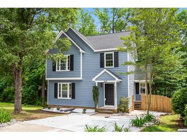 Charming two-story home with blue siding, black shutters, and a well-manicured lawn, creating a welcoming curb appeal at 214 Wax Myrtle Ct, Cary, NC 27513