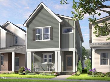 Charming two-story home featuring vertical siding, white trim, inviting front porch with rocking chairs and manicured lawn at 340 Cottage Hill Way, Raleigh, NC 27604