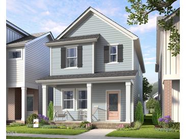 Charming two-story home with a cozy front porch, offering a welcoming curb appeal and a delightful outdoor space at 346 Cottage Hill Way, Raleigh, NC 27604