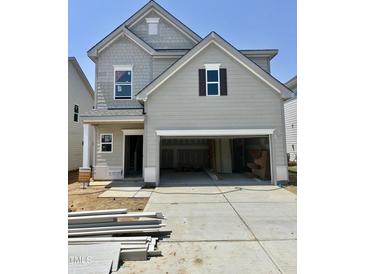 Charming two-story home with a gray exterior, a two car garage and an available sign at 51 Commons Cir, Clayton, NC 27520