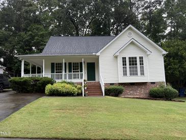 Charming one-story home featuring a welcoming front porch and well-maintained landscaping at 6321 Lymington Dr, Raleigh, NC 27616