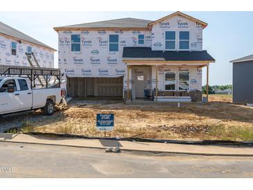 New construction home featuring Tyvek HomeWrap and pre-installed roof, offering a glimpse of future potential at 698 White Birch Ln, Angier, NC 27501
