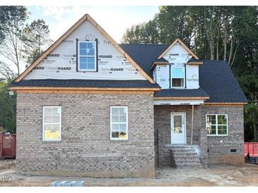 New construction home featuring a brick facade, black roof, and bright windows awaiting finishing touches at 824 Emmett Ct, Spring Hope, NC 27882