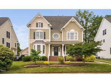 Charming two-story home with detailed trim, manicured lawn, and a welcoming front porch at 128 Low Country Ct, Morrisville, NC 27560