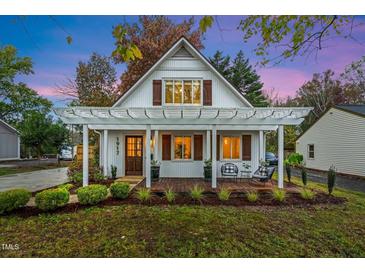 Charming home with a inviting front porch and beautiful landscaping, perfect for enjoying outdoor living at 1917 Washington St, Durham, NC 27704