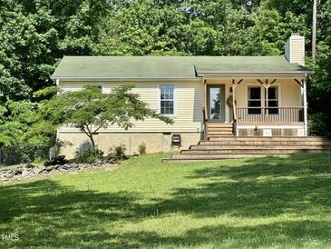 Charming single-story home with a welcoming front porch and a well-maintained lawn at 280 Sagamore Dr, Louisburg, NC 27549
