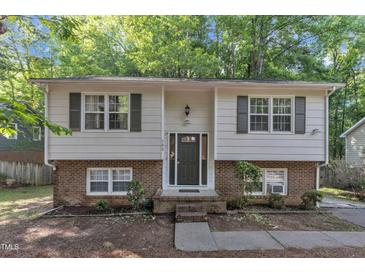 Charming two-story home with light siding, brick accents, and symmetrical windows and shutters at 309 Penn Oak Cir, Raleigh, NC 27615