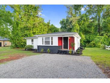 Charming renovated single-story home features a red accent wall and updated landscaping at 313 W Church St, Angier, NC 27501