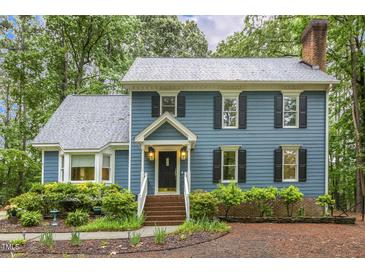Charming two-story home with blue siding, black shutters, and a well-maintained landscaped front yard at 3420 Greenville Loop Rd, Wake Forest, NC 27587