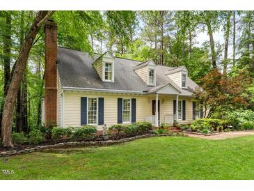 Charming home with manicured lawn,dormers, and mature landscaping providing an inviting curb appeal at 4 Barkridge Ct, Durham, NC 27713