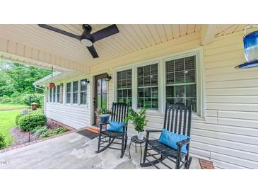 Inviting front porch with ceiling fan and rocking chairs; perfect for relaxing outdoors at 41 Maple Cir, Pittsboro, NC 27312