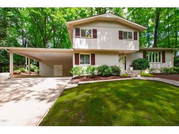 Charming two-story home with landscaped front yard and attached carport at 4213 Oak Park Rd, Raleigh, NC 27612