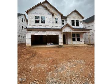 New two-story home with a two-car garage awaiting exterior finishing at 452 Golden Dragonfly St, Wake Forest, NC 27587