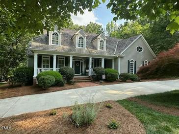 Charming home with a manicured lawn, inviting front porch, and well-maintained landscaping at 1009 Bearglades Ln, Raleigh, NC 27615