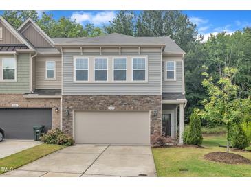 Charming townhome featuring a two-car garage and tasteful stone accents on the facade at 1022 Flagler St, Durham, NC 27713