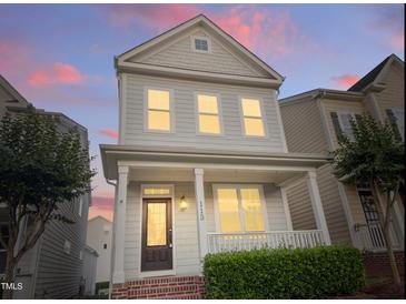 Charming two-story home features a welcoming porch and manicured landscaping at 113 Windy Creek Ln, Apex, NC 27502