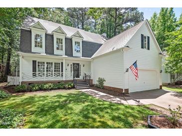 Charming two-story home with a white picket fence and well-manicured lawn at 115 Nuttree Way, Durham, NC 27713
