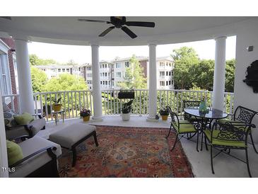 Inviting outdoor patio featuring elegant columns, comfortable seating, and scenic neighborhood views at 2901 Market Bridge Ln # 203, Raleigh, NC 27608