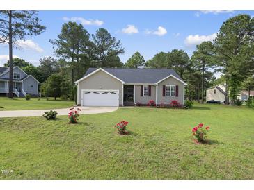Charming home featuring a well-manicured lawn, attached garage, and inviting curb appeal at 30 Cornerstone Dr, Franklinton, NC 27525