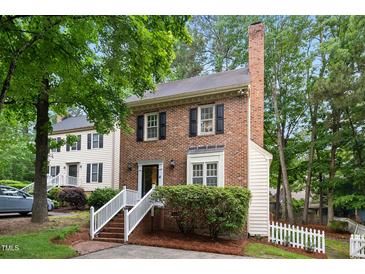 Charming two-story brick home with white trim and lush green landscaping at 4 Weathergreen Ct, Durham, NC 27713
