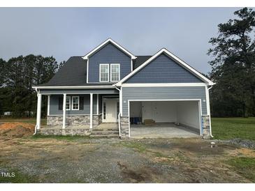 New construction home featuring stone accents, a two-car garage, and a covered front porch at 4167 Old Stage N Rd # 4, Angier, NC 27501