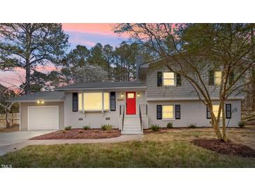 Charming two-story home featuring a bright red front door and well-maintained landscaping at 4307 Pope Rd, Durham, NC 27707
