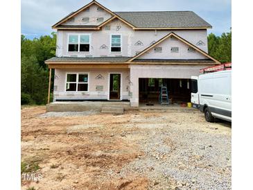 Two-story home under construction featuring a spacious two-car garage and ample windows for natural light at 50 Moonraker Dr, Spring Hope, NC 27882